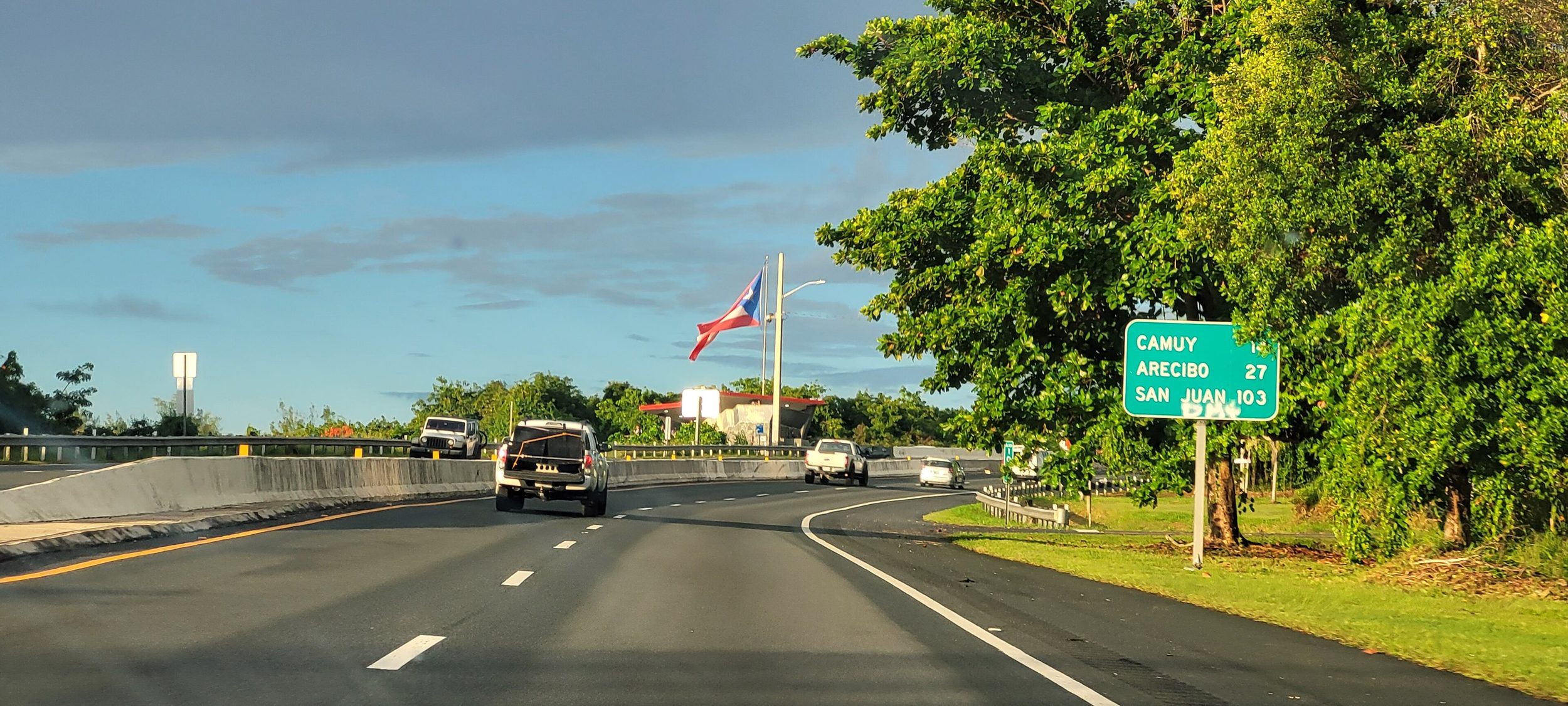 Driving PR-2 near Quebradillas, the roadsign counting down to Camuy